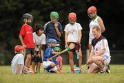 11 December 2009; Galway's Ollie Canning with children from the local Hurlinghan Hurling Club during a light training / coaching session in advance of the game. GAA Hurling All-Stars Tour 2009 sponsored by Vodafone, Hurlingham Grounds, Hurlingham, Buenos Aires, Argentina. Picture credit: Ray McManus / SPORTSFILE