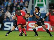 19 December 2009; Deacon Manu, Llanelli Scarlets, is tackled by Brian O'Driscoll and Isa Nacewa, right, Leinster. Heineken Cup Pool 6 Round 4, Leinster v Llanelli Scarlets, RDS, Dublin. Photo by Sportsfile