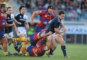 20 December 2009; David Wallace, Munster, is tackled by Bertrand Guiry and Nicolas Mas, 3, Perpignan. Heineken Cup Pool 1 Round 4, Perpignan v Munster, Stade Aime Giral, Perpignan, France. Picture credit: Brendan Moran / SPORTSFILE