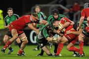26 December 2009; Julien Brugnaut, supported by team-mate Mick O'Driscoll, left, Munster, is tackled by Johnny O'Connor, left, Andrew Browne, centre, and Ronan Loughney, Connacht. Celtic League, Munster v Connacht, Thomond Park, Limerick. Picture credit: Diarmuid Greene / SPORTSFILE