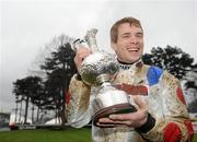 29 December 2009; Jockey Sam Thomas with the Lexus Chase Perpetual Trophy after winning the Lexus Steeplechase aboard What A Friend. Leopardstown Christmas Racing Festival 2009, Leopardstown Racecourse, Dublin. Picture credit: Brian Lawless / SPORTSFILE