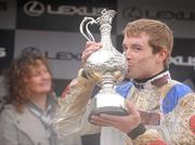 29 December 2009; Jockey Sam Thomas with the Lexus Chase Perpetual Trophy after winning the Lexus Steeplechase aboard What A Friend. Leopardstown Christmas Racing Festival 2009, Leopardstown Racecourse, Dublin. Picture credit: Brian Lawless / SPORTSFILE