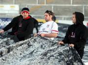 8 January 2010; Ulster's Ian Humphreys, Isaac Boss and Paul Marshall helping put covers on the pitch at Ravenhill, in preparation for a massive marquee and heat blowers to ensure next Friday night's Heineken Cup clash with Edinburgh beats the big freeze. Ravenhill Park, Belfast, Co. Antrim. Picture credit: John Dickson / SPORTSFILE