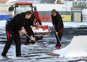 8 January 2010; Ulster's Ed O'Donoghue and Thomas Anderson help to clear the snow before putting covers on the pitch at Ravenhill, in preparation for a massive marquee and heat blowers to ensure next Friday night's Heineken Cup clash with Edinburgh beats the big freeze. Ravenhill Park, Belfast, Co. Antrim. Picture credit: John Dickson / SPORTSFILE