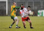 20 January 2010; Gareth Devlin, Tyrone, in action against James Keeney, Donegal. Barrett Sports Lighting Dr. McKenna Cup, Group B, Donegal v Tyrone, MacCumhaill Park, Ballybofey, Co. Donegal. Picture credit: Oliver McVeigh / SPORTSFILE