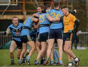 20 February 2016; University College Dublin players celebrate at the final whistle as a dejected Cian Brehany, Dublin City University, watches on. Independent.ie HE GAA Sigerson Cup Final, University College Dublin v Dublin City University, UUJ, Jordanstown, Co. Antrim. Picture credit: Oliver McVeigh / SPORTSFILE