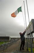 21 February 2016; John Nolan, Innovate Wexford Park groundsman, and father of Irish boxer Adam Nolan raises the tricolour ahead of the game. Allianz Hurling League, Division 1B, Round 2, Wexford v Clare. Innovate Wexford Park, Wexford. Picture credit: Piaras Ó Mídheach / SPORTSFILE