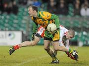 20 January 2010; Colm McFadden, Donegal, in action against Kevin Hughes, Tyrone. Barrett Sports Lighting Dr. McKenna Cup, Group B, Donegal v Tyrone, MacCumhaill Park, Ballybofey, Co. Donegal. Picture credit: Oliver McVeigh / SPORTSFILE