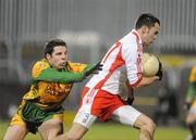 20 January 2010; Kyle Coney, Tyrone, in action against Kevin Cassidy, Donegal. Barrett Sports Lighting Dr. McKenna Cup, Group B, Donegal v Tyrone, MacCumhaill Park, Ballybofey, Co. Donegal. Picture credit: Oliver McVeigh / SPORTSFILE