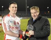 27 January 2010; Tyrone's Tommy McGuigan, receives the Barrett Sports Lighting Man of the Match, from Martin Barrett, Chief Executive, Barrett Sports Lighting. Barrett Sports Lighting Dr. McKenna Cup Semi-Final, Tyrone v Fermanagh, Healy Park, Omagh, Co. Tyrone. Picture credit: Oliver McVeigh / SPORTSFILE