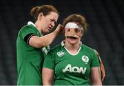 27 February 2016; Ailis Egan has her protective strapping removed by her Ireland team-mate Marie Louise Reilly after the game. Women's Six Nations Rugby Championship, England v Ireland. Twickenham Stadium, Twickenham, London, England. Picture credit: Stephen McCarthy / SPORTSFILE