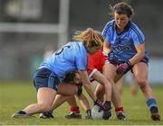 28 February 2016; Doireann O'SullEvan, Cork, is tackled by Sinead Finnegan, left, and Leah Caffrey, Dublin. Lidl Ladies Football National League, Division 1, Dublin v Cork, Parnell Park, Dublin. Picture credit: Ramsey Cardy / SPORTSFILE