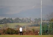 6 February 2010; Umpire Noel Nugent, from Mullingar watches the game, with Mount Leinster in the background. Walsh Cup Semi-Final, Wexford v Dublin, Pairc Ui Siochan, Gorey, Co. Wexford. Picture credit: Daire Brennan / SPORTSFILE