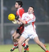 6 February 2010; Liam Hinphey, Derry, in action against Kyle Coney, Tyrone. Allianz GAA Football National League, Division 1, Round 1, Derry v Tyrone, Celtic Park, Derry. Picture credit: Oliver McVeigh / SPORTSFILE