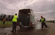 16 April 2001; Officials spray disinfectant on a horsebox at the entrance to Leopardstown Racecourse in Dublin on the first day back of Horse Racing in Ireland since Racing was suspended due to foot and mouth. Photo by Matt Browne/Sportsfile