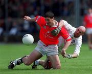 22 April 2001; Fionan Murray of Cork is tackled by David Hughes of Kildare during the Allianz GAA National Football League Division 2 Semi-Final match between Cork and Kildare at McDonagh Park in Nenagh, Tipperary. Photo by Ray McManus/Sportsfile