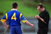 15 April 2001; Referee Michael Carroll takes the name of Gerry Byrne of Wicklow during the Leinster Senior Hurling Championship First Preliminary Round match between Wicklow and Kildare at Pearse Park in Arklow, Wicklow. Photo by Ray McManus/Sportsfile