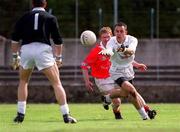 22 April 2001; Brian Lacey of Kildare passes back to his goalkeeper Christy Byrne under pressure from Aidan Dorgan of Cork during the Allianz GAA National Football League Division 2 Semi-Final match between Cork and Kildare at McDonagh Park in Nenagh, Tipperary. Photo by Ray McManus/Sportsfile