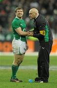13 February 2010; Ireland's Gordon D'Arcy winces with pain as he is attended to by Team Doctor Eanna Falvey after the match. RBS Six Nations Rugby Championship, France v Ireland, Stade de France, Saint Denis, Paris, France. Picture credit: Brian Lawless / SPORTSFILE