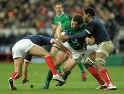 13 February 2010; Cian Healy, Ireland, is tackled by Francois Trinh-Duc, left, and Fulgence Ouedraogo, France. RBS Six Nations Rugby Championship, France v Ireland, Stade de France, Saint Denis, Paris, France. Picture credit: Brian Lawless / SPORTSFILE