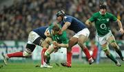13 February 2010; Brian O'Driscoll, Ireland, is tackled by Imanol Harinordoquy, left, and theirry Dusautoir, France. RBS Six Nations Rugby Championship, France v Ireland, Stade de France, Saint Denis, Paris, France. Picture credit: Brendan Moran / SPORTSFILE