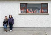 14 February 2010; Two young girls watch on as the Westmeath team warm up before the game and Armagh players look on from their dressing room. Allianz National Football League, Division 2, Round 2, Armagh v Westmeath, St Oliver Plunkett Park, Crossmaglen, Co. Armagh. Photo by Sportsfile
