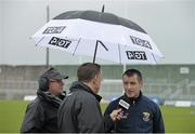 6 March 2016; TG4 Floor manager Odhrán Mac Murchadha holds an umbrella as Wexford manager Liam Dunne is interviewed by Michéal O Domhnaill of TG4 before the game. Allianz Hurling League, Division 1B, Round 3, Kerry v Wexford. Austin Stack Park, Tralee, Co. Kerry. Picture credit: Brendan Moran / SPORTSFILE