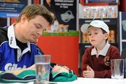 15 February 2010; Glen Browne, age 6, from Ballybrack, Co. Dublin, looks on inquisitively as he gets a jersey signed by Gillette Ambassador and Irish Rugby captain Brian O’Driscoll at an in-store signing in Dunnes Stores, Cornelscourt, on Monday evening. The rugby hero took the time to sign autographs and meet hundreds of fans as he launched the Gillette Fusion limited edition Irish handle razor. A limited edition razor has been specially designed donning the Irish colours to show Ireland’s pride in the rugby star and his Irish team-mates. The crowd were delighted to get the opportunity to meet the rugby star before he lines out for his next RBS 6 Nations match against England. Dunnes Stores, Cornelscourt, Dublin. Picture credit: Brendan Moran / SPORTSFILE