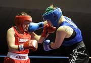 19 February 2010; Patricia Roddy, Bray, blue, exchanges punches with Nichola Hamill, Gleann, red, during their 69kg Women's bout. National Mens and Womens Elite National Boxing Championships, Preliminary Rounds, National Stadium, Dublin. Picture credit: Stephen McCarthy / SPORTSFILE