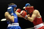 19 February 2010; Ronan Brennan, Dealgan, red, and Shane Murtagh, Crumlin, blue, exchange punches during their 69kg bout. National Mens and Womens Elite National Boxing Championships, Preliminary Rounds, National Stadium, Dublin. Picture credit: Stephen McCarthy / SPORTSFILE