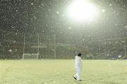 20 February 2010; Umpire Seamus O'Brien waits on the pitch amid falling snow before the game was called off. Allianz GAA Hurling National League, Division 1 Round 1, Tipperary v Kilkenny, Semple Stadium, Thurles, Co. Tipperary. Picture credit: Brendan Moran / SPORTSFILE
