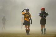21 February 2010; Claire Dallat, 10, Queen's University, and Laura Newman, National University of Ireland watch the play during a rising mist. Purcell Shield Final. Queen's University, Belfast, v National University of Ireland, Maynooth, pitch 3, Cork Institute of Technology, Cork. Picture credit: Ray McManus / SPORTSFILE