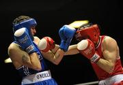 19 February 2010; Ronan Brennan, Dealgan, red, and Shane Murtagh, Crumlin, blue, exchange punches during their 69kg bout. National Mens and Womens Elite National Boxing Championships, Preliminary Rounds, National Stadium, Dublin. Picture credit: Stephen McCarthy / SPORTSFILE