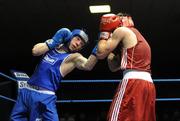 20 February 2010; Ray Moylette, St Annes, blue, exchange punches with Philip Sutcliffe, Crumlin, red, during their 64kg bout. National Boxing Championships - Semi-Finals, National Stadium, Dublin. Picture credit: Stephen McCarthy / SPORTSFILE