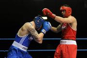 20 February 2010; Kenny Egan, Neilstown, red and Denis Hogan, Grangecon blue, exchange punches during their 81kg bout. National Boxing Championships - Semi-Finals, National Stadium, Dublin. Picture credit: Stephen McCarthy / SPORTSFILE