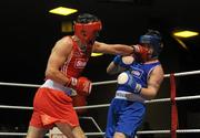 20 February 2010; Kenny Egan, Neilstown, red lands a left on Denis Hogan, Grangecon, blue, during their 81kg bout. National Boxing Championships - Semi-Finals, National Stadium, Dublin. Picture credit: Stephen McCarthy / SPORTSFILE