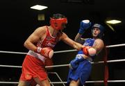 20 February 2010; Kenny Egan, Neilstown, red and Denis Hogan, Grangecon, blue, exchange punches during their 81kg bout. National Boxing Championships - Semi-Finals, National Stadium, Dublin. Picture credit: Stephen McCarthy / SPORTSFILE