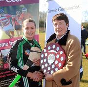 21 February 2010; The Queen's University captain Shauna Jordan is presented with the Purcell Shield by Lynn Kelly, President of 3rd Level Camogie Association, after the final. Purcell Shield Final, Queen's University, Belfast, v National University of Ireland, Maynooth, pitch 3, Cork Institute of Technology, Cork. Picture credit: Ray McManus / SPORTSFILE