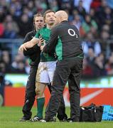 27 February 2010; Ireland captain Brian O'Driscoll is held up by team physio Cameron Steele and team doctor Dr. Eanna Falvey after falling to the ground twice with suspected concussion during the game. RBS Six Nations Rugby Championship, England v Ireland, Twickenham Stadium, Twickenham, London, England. Picture credit: Brendan Moran / SPORTSFILE
