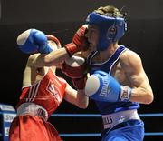 27 February 2010; Conor Ahern, Baldoyle, blue, exchanges punches with Michael Conlan, St John Bosco, red, during their 51kg bout. National Mens Elite Championships Semi-Finals - Saturday, National Stadium, Dublin. Picture credit: Stephen McCarthy / SPORTSFILE