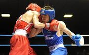 27 February 2010; Conor Ahern, Baldoyle, blue, exchanges punches with Michael Conlan, St John Bosco, red, during their 51kg bout. National Mens Elite Championships Semi-Finals - Saturday, National Stadium, Dublin. Picture credit: Stephen McCarthy / SPORTSFILE