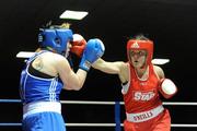 27 February 2010; Kelly Harrington, West Finglas, red, exchanges punches with Patricia Roddy, Bray, blue, during their elite women's 69kg bout. National Mens & Womens Elite Championships Semi-Finals - Saturday, National Stadium, Dublin. Picture credit: Stephen McCarthy / SPORTSFILE
