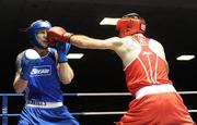 27 February 2010; John Joe Joyce, St Michaels Athy, red, lands a left on Roy Sheehan, St Michaels Athy, blue, during their 69kg bout. National Mens Elite Championships Semi-Finals - Saturday, National Stadium, Dublin. Picture credit: Stephen McCarthy / SPORTSFILE