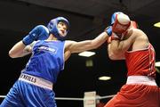 27 February 2010; Roy Sheehan, St Michaels Athy, blue, throws a left at John Joe Joyce, St Michaels Athy, red, during their 69kg bout. National Mens Elite Championships Semi-Finals - Saturday, National Stadium, Dublin. Picture credit: Stephen McCarthy / SPORTSFILE