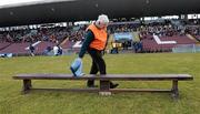 28 February 2010; Pearse stadium stewart Sean McManamon wipes the bench before the team arrive for the traditional team photograph. Allianz GAA National Hurling League Division 1 Round 2, Galway v Waterford, Pearse Stadium, Galway. Picture credit: Ray Ryan / SPORTSFILE