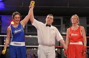 5 March 2010; Kelly Harrington, West Finglas, is announced victorious over Jessica Lyons, St Francis, Limerick, by referee James McCarron following their elite women's 69kg final bout. National Men's & Women's Elite National Championships 2010 Finals - Friday, National Stadium, Dublin. Picture credit: Stephen McCarthy / SPORTSFILE
