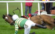 27 April 2001; Jockey Charlie Swan and Istabraq after falling at the last fence during the Shell Champion Hurdle at Leopardstown Racecourse in Dublin. Photo by Matt Browne/Sportsfile