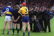 6 May 2001; Referee Pat O'Connor with team captains Thomas Dunne of Tipperary and Brian Lohan of Clare before the Allianz National Hurling League Final match between Tipperary and Clare at the Gaelic Grounds in Limerick. Photo by Ray McManus/Sportsfile