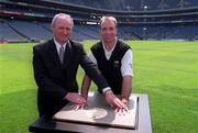 10 May 2001; Michael Whelan, Head of Sponsorship of Guinness Ireland, with DJ Carey, last seasons &quot;Hurler of the Year', who was honoured again for his exploits of the summer of 2000 at the launch of the 2001 Guinness All Ireland Championship. DJ received the 'Giants of Hurling' treatment when his handprints and signature were captured in concrete at a function held in Croke Park. The completed concrete artwork is being presented to the City of Kilkenny where it will be permanently located. Photo by Ray McManus/Sportsfile