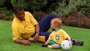 11 May 2001; Brazilian soccer legend Jairzinho flew into Dublin today to start a ten day Irish tour to launch and promote the 2001 Samba Soccer School Coaching programme throughout the country. Here he's pictured with Fionn Carroll, aged one and a half. Photo by Damien Eagers/Sportsfile